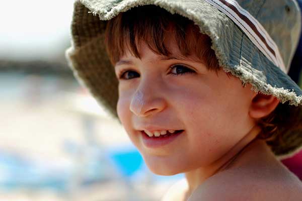 Boy wearing sunscreen - learn about formulating sunscreens with metal oxides in the Prospector Knowledge Center.