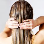 Woman washing her hair - learn how the pH of shampoo influences its efficacy in the UL Prospector Knowledge Center.