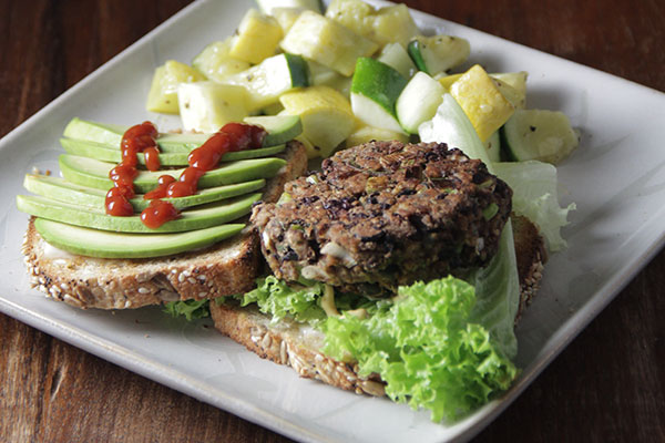 Black bean burger with avocado on plate - learn about how to increase nutritional value with blended proteins in the Prospector Knowledge Center