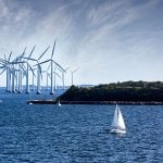 white Wind turbines in the ocean