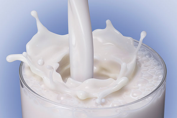 milk splashing into a glass