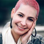 Woman with pink hair smiling